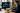 Modern workspace with AI tools assisting professional tasks